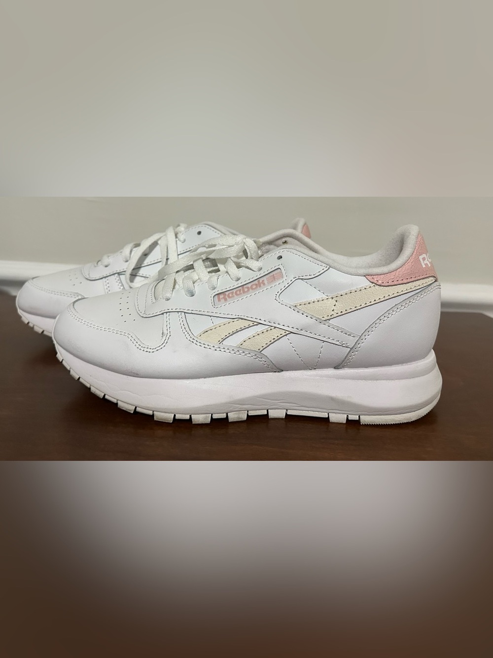 Woman’s pink and white leather Reebok classic sneaker